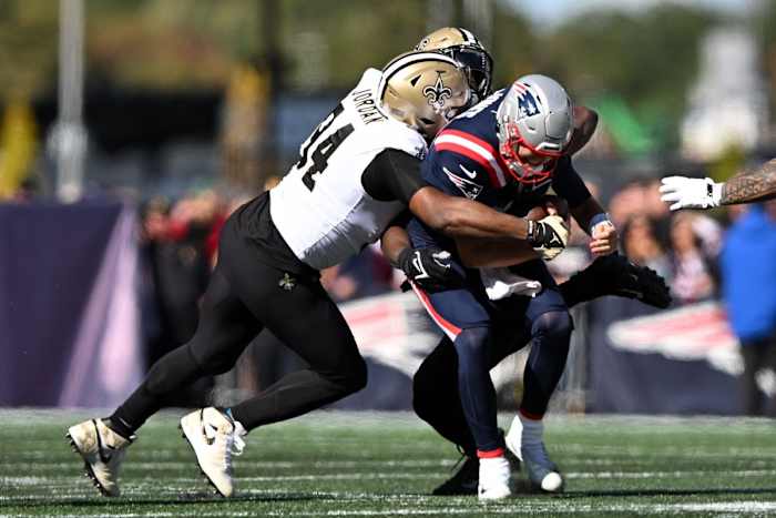 Oct 8, 2023; New England Patriots quarterback Mac Jones (10) is sacked by New Orleans Saints defensive ends Tanoh Kpassagnon (92) and Cameron Jordan (94). Mandatory Credit: Brian Fluharty-USA TODAY Sports